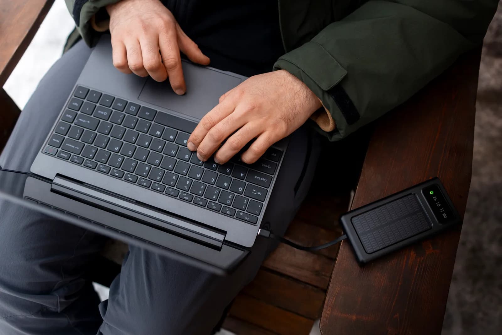 A shopper browsing a gun store website on a laptop outdoors